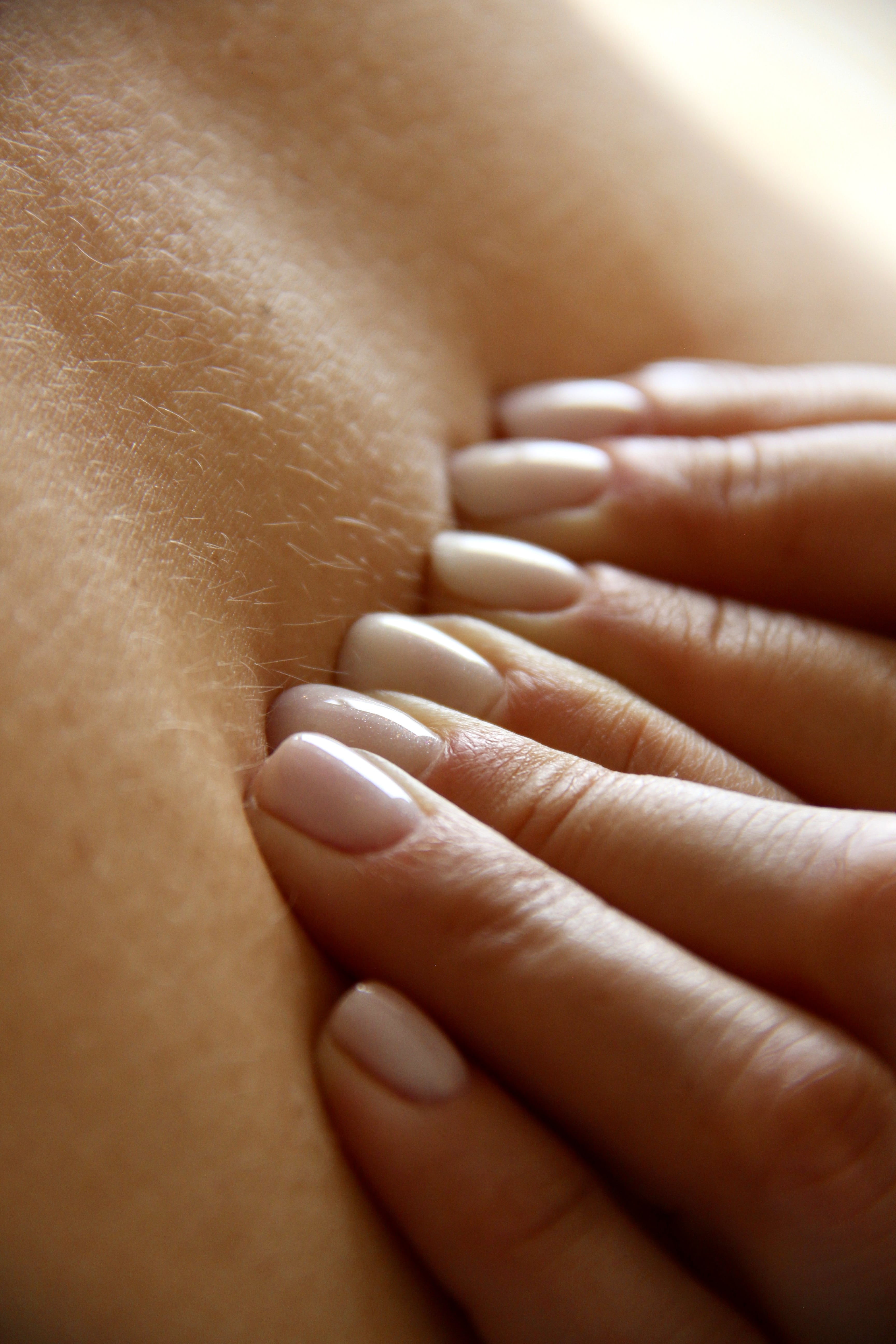 Close-up of hands performing therapeutic osteopathic techniques
